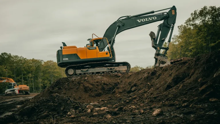 Heavy-duty excavator digging and grading soil for site preparation.